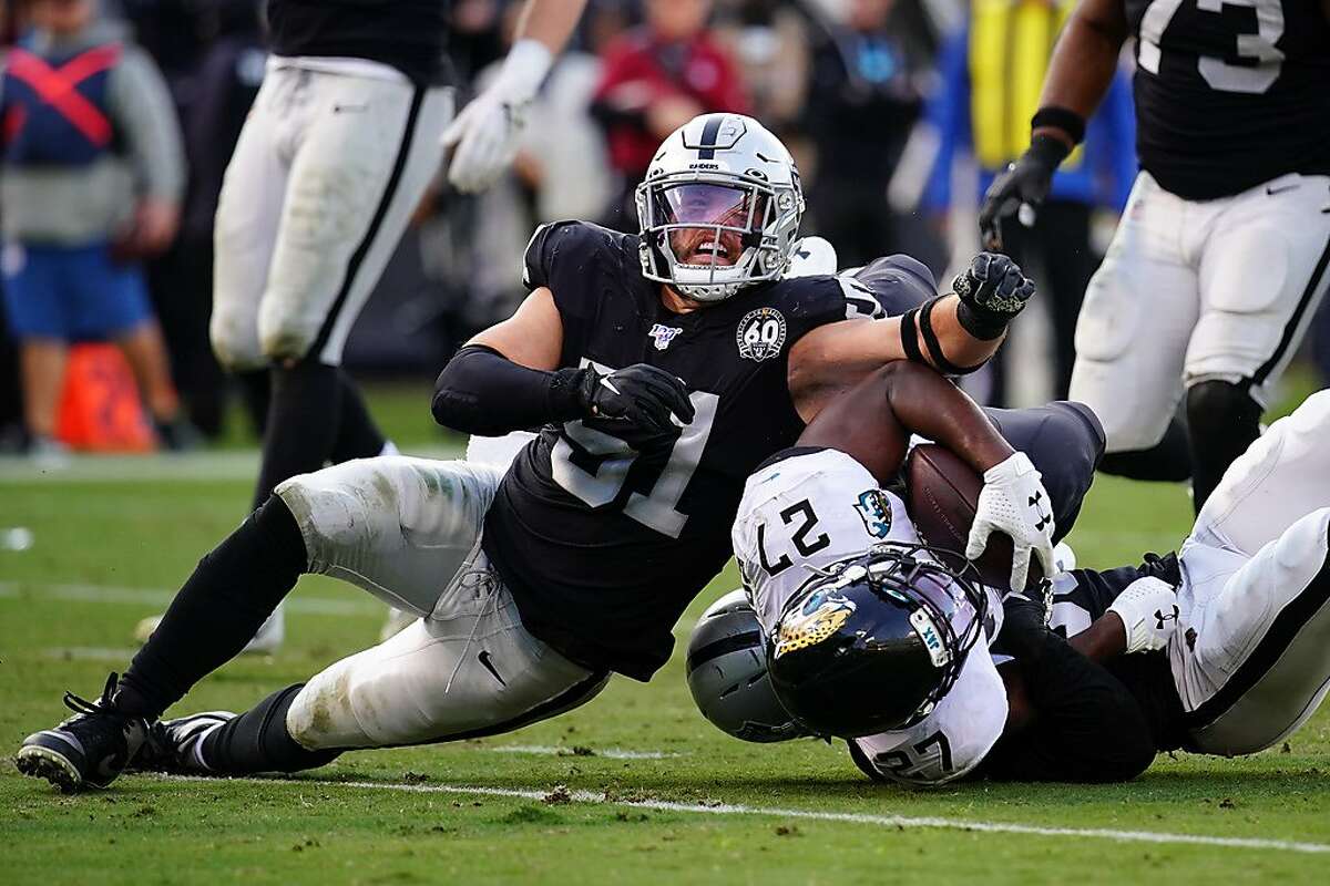OAKLAND, CALIFORNIA - DECEMBER 15: Leonard Fournette #27 of the Oakland Raiders is tackled by Will Compton #51 of the Oakland Raiders during the second half at RingCentral Coliseum on December 15, 2019 in Oakland, California. (Photo by Daniel Shirey/Getty Images)