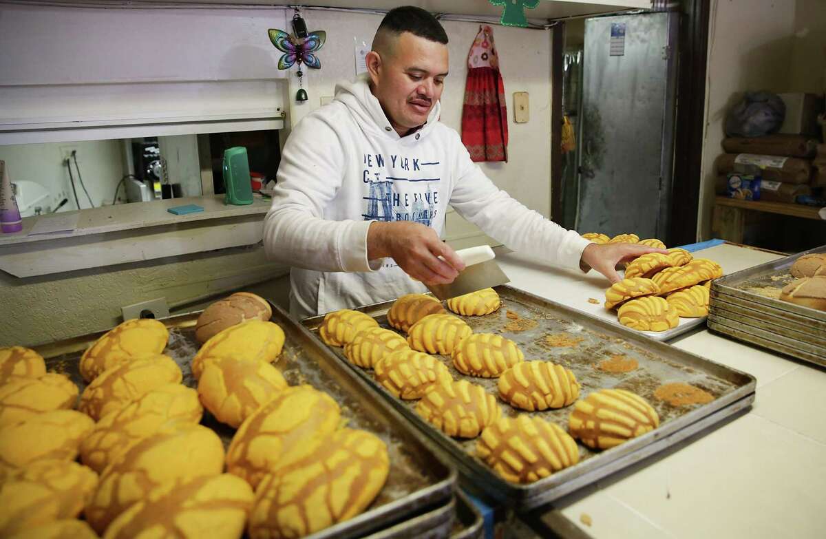 Wilmer Caballero, head baker and owner at Caballero Bakery on Pinn Road serves some conchas he made.