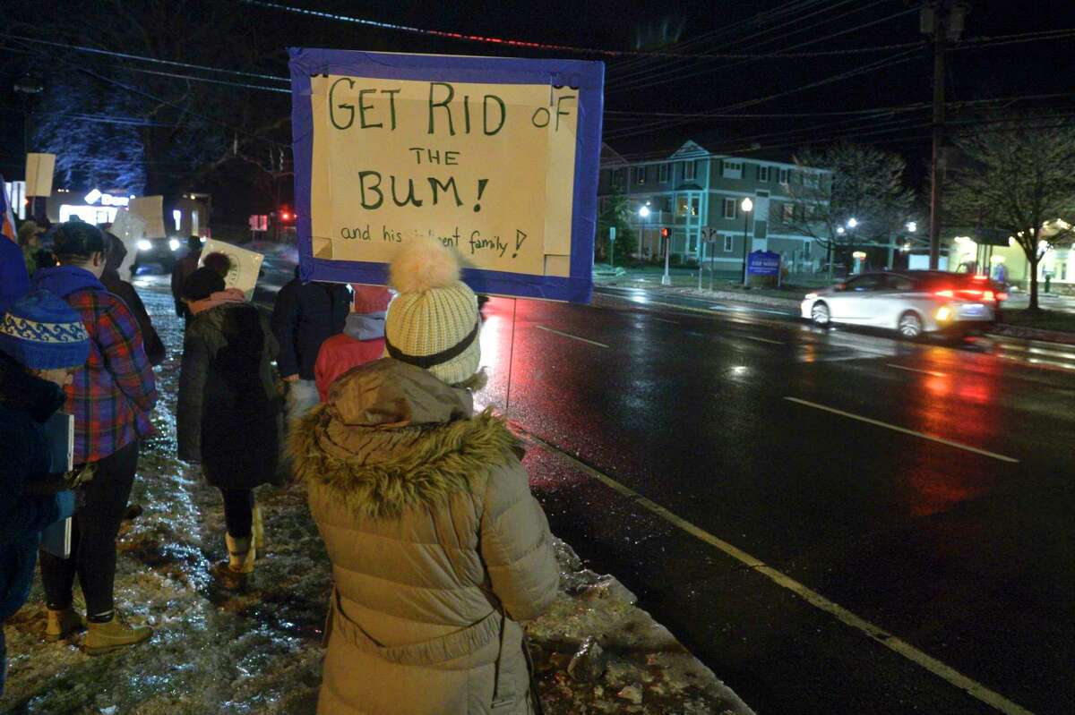 Rose Witte, of Redding, holds a sign as community members rally for the impeachment of President Trump at the corner of Greenwood Ave and Route 53 on Tuesday evening. December 17, 2019, in Bethel, Conn.