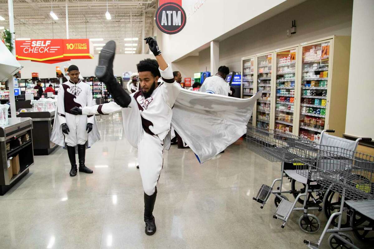 Joshua Stewart, 20, member of the Texas Southern University’s marching band Ocean of Soul practices his moves in the new H-E-B MacGregor Market on Tuesday, Dec. 17, 2019, in Houston while waiting for the opening store reception.