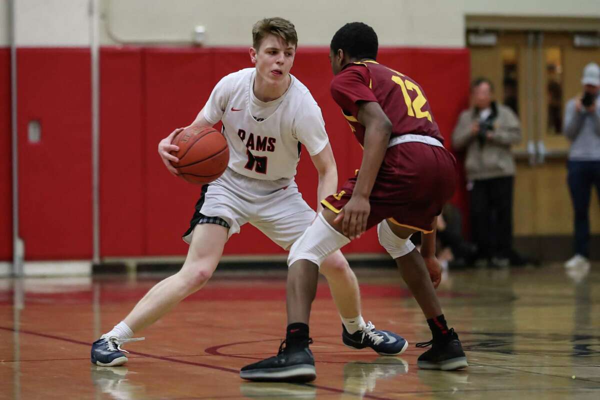 Ryan McAleer (10) of New Canaan tries to shake away Jason James (12) of St. Joseph during the Division IV Semi Final game between St. Joseph High School Boys Varsity Basketball and New Canaan Boys Varsity Basketball on March 12, 2019 at Warde - Fairfield High School in Fairfield, CT.