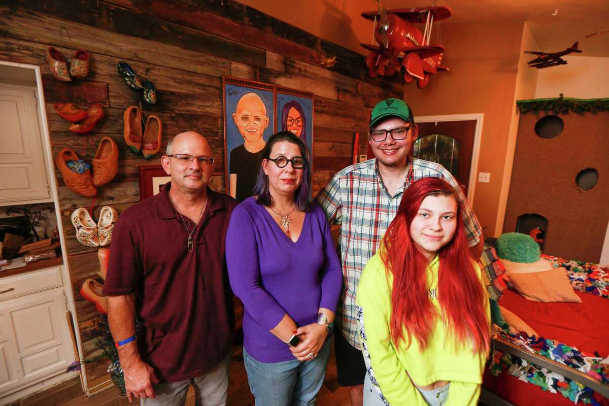 Elizabeth Burnham (second from left), a Houston artist who sustained five feet of water damage at her Bear Creek home, is now working on her new home with her husband, Kenneth Gwynne (left), and her son Trysten and daughter Josena Burnham Tuesday, Dec. 17, 2019, in Houston.