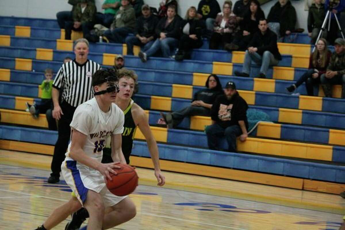 Evart's Donovan Duncan (10) goes to the basket against the McBain defense in Monday night action. (Pioneer photo/John Raffel)
