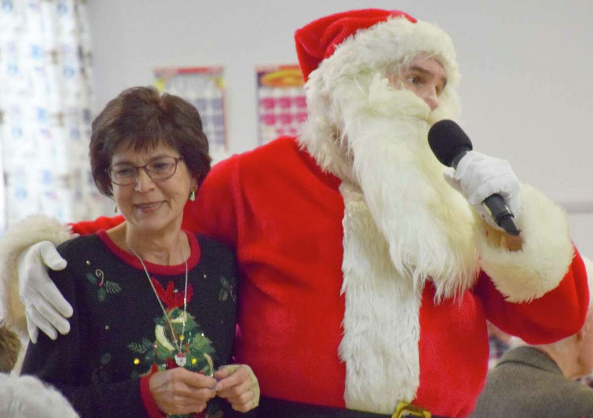 Santa teams up with Angie Edmonds of New Milford to make an announcement about the party’s happenings.