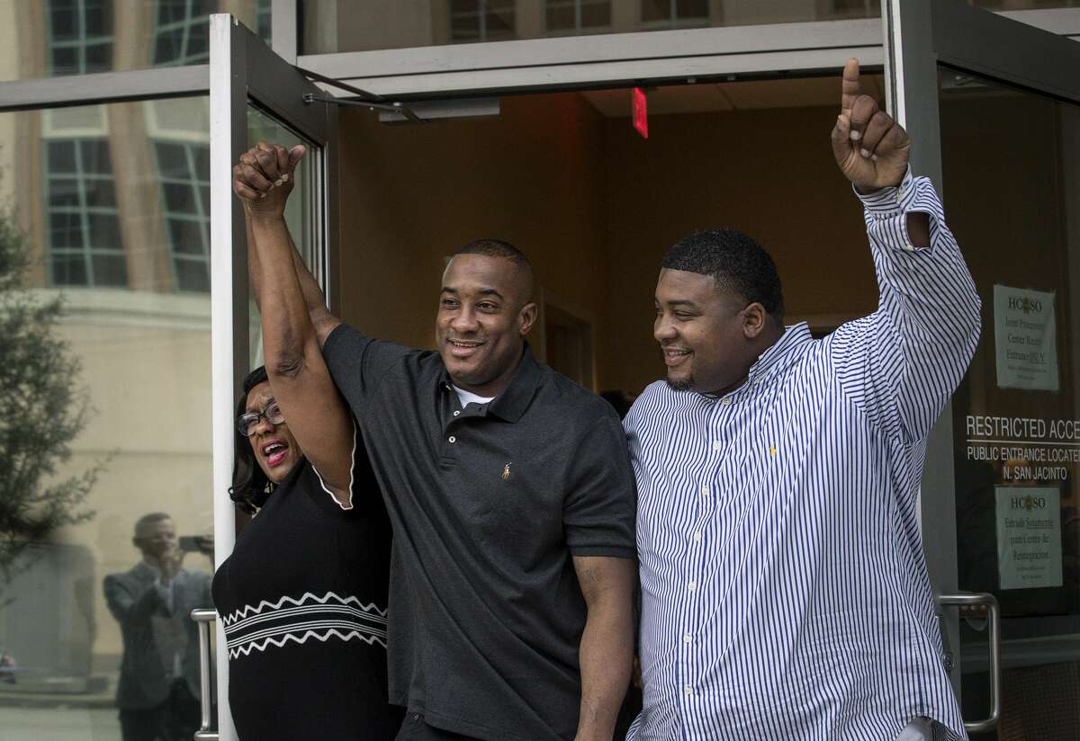 Lydell Grant, center, his mother Donna Poe, left, and brother Alonzo Poe celebrate Grant's release on bond on Tuesday, Nov. 26, 2019, in Houston. Earlier in the day, Grant was ordered released on bond after prosecutors and defense attorneys with the Innocence Project of Texas agreed that Grant should be released while the case is investigated further in light of new DNA evidence. Grant was convicted of capital murder in the 2010 stabbing death of Aaron Scheerhoorn outside of a Montrose bar, and he had spent seven years behind bars.