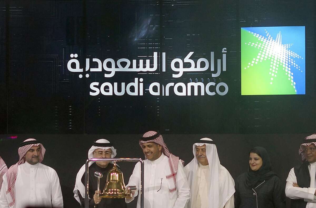 FILE - In Dec. 11, 2019, file photo Saudi Arabia's state-owned oil company Armco and stock market officials celebrate during the official ceremony marking the debut of Aramco's initial public offering (IPO) on the Riyadh's stock market, in Riyadh, Saudi Arabia.