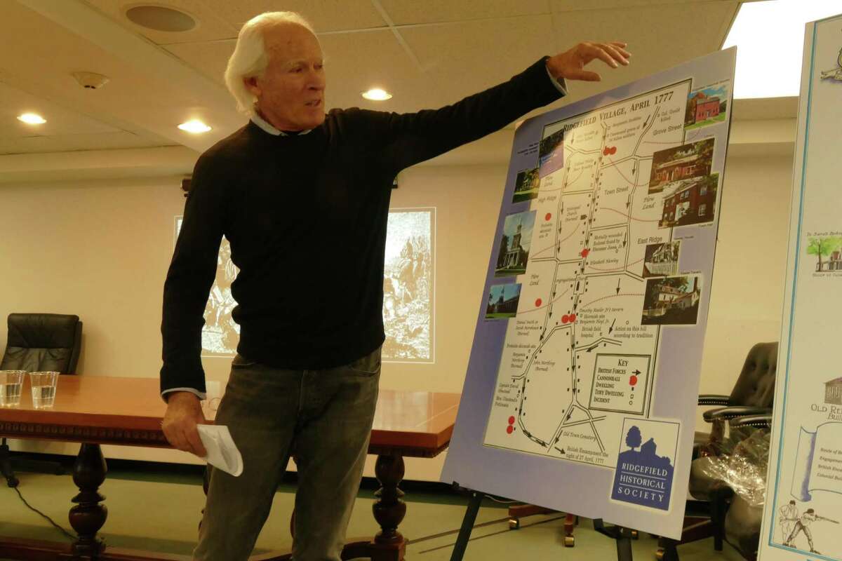 Historian Keith Jones speaks to a crowd of about 50 residents inside Ridgefield’s town hall on Wednesday, Dec. 18.