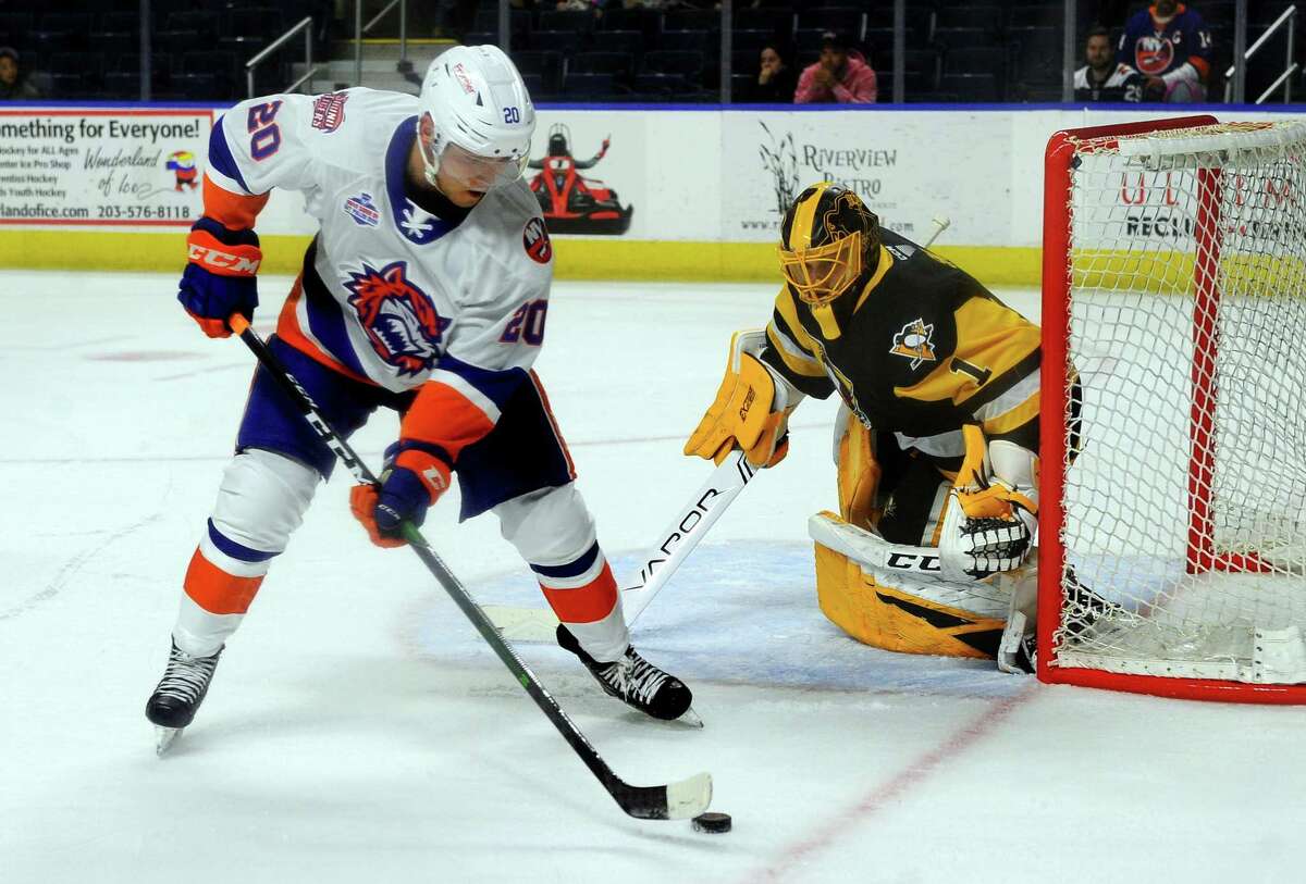 The Sound Tigers' Kieffer Bellows (20) gets the puck near the W-B/Scranton goalie Casey DeSmith at the Webster Bank Arena in Bridgeport last season.