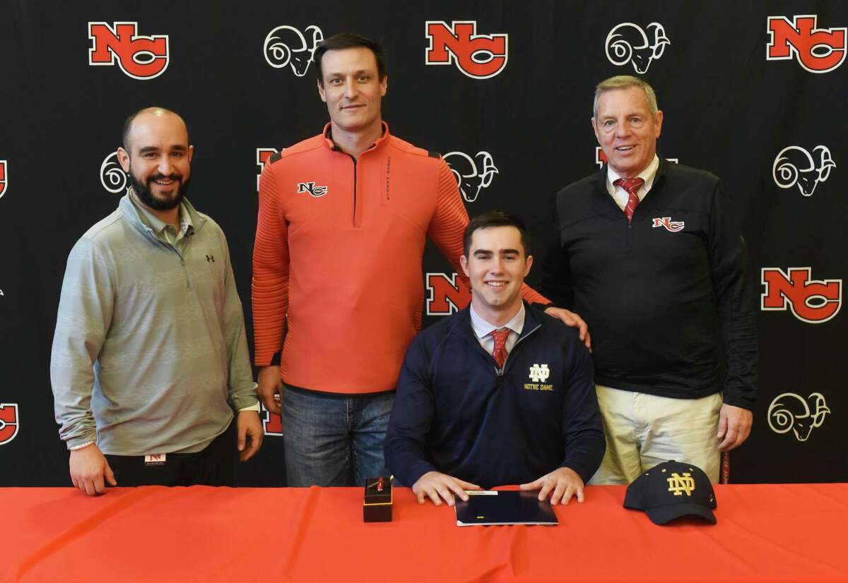 New Canaan senior Drew Pyne with Ram coaches, from left, AJ Albano, Chris Silvestri and Lou Marinelli during the first day of the early signing period for football on Wednesday, Dec. 18, 2019, at NCHS. Pyne signed his National Letter of Intent to play for Notre Dame.