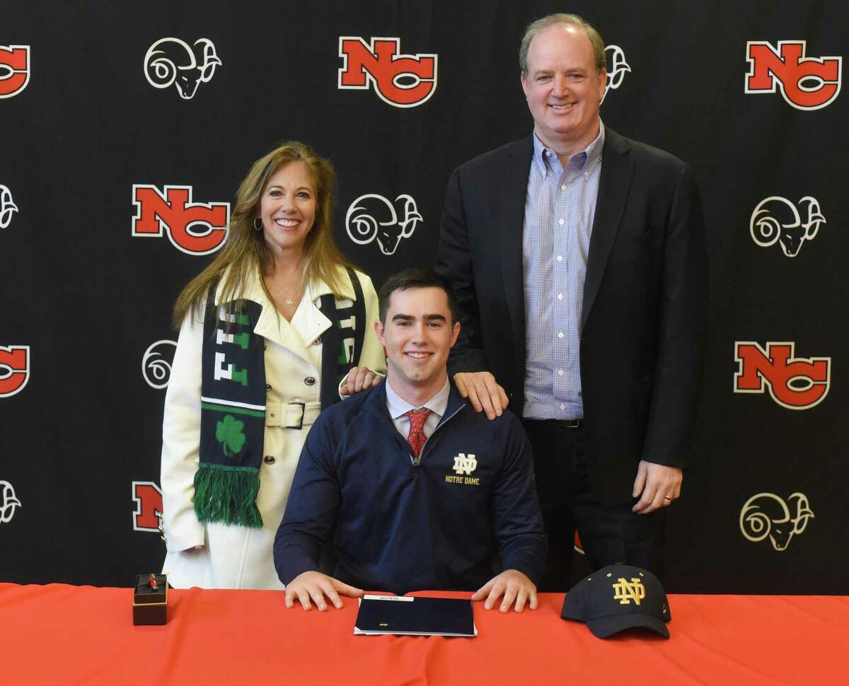 New Canaan senior Drew Pyne with his parents, Helene and George, during the first day of the early signing period for football on Wednesday, Dec. 18, 2019, at NCHS. Pyne signed his National Letter of Intent to play for Notre Dame.