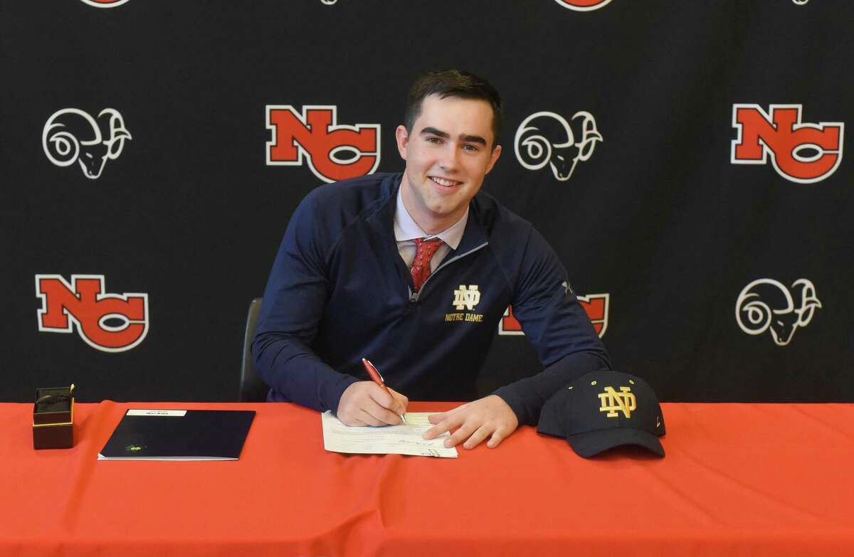 New Canaan senior Drew Pyne signs his National Letter of Intent to play football for Notre Dame, during the first day of the early signing period on Wednesday.