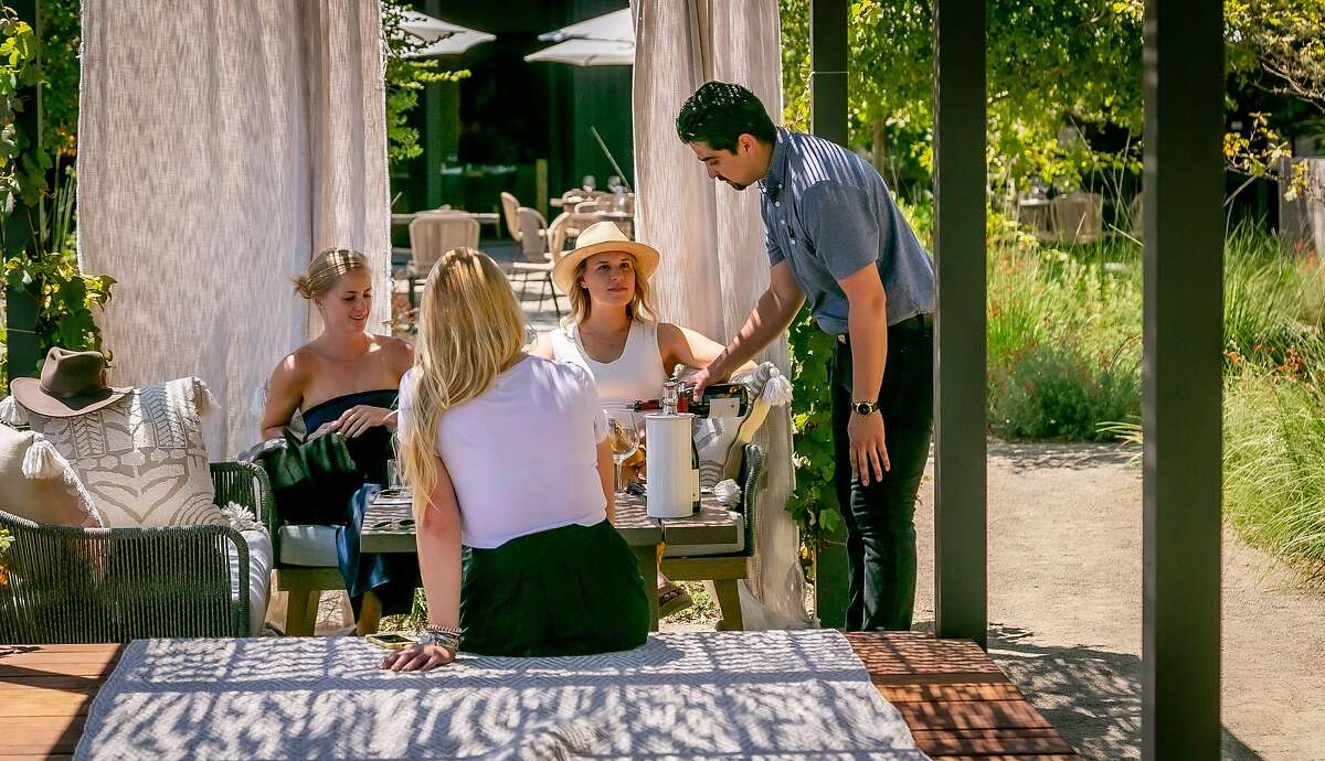 Alexander Guitterez pours wine for guests at Flowers Winery in Healdsburg, Calif. on August 11, 2019.