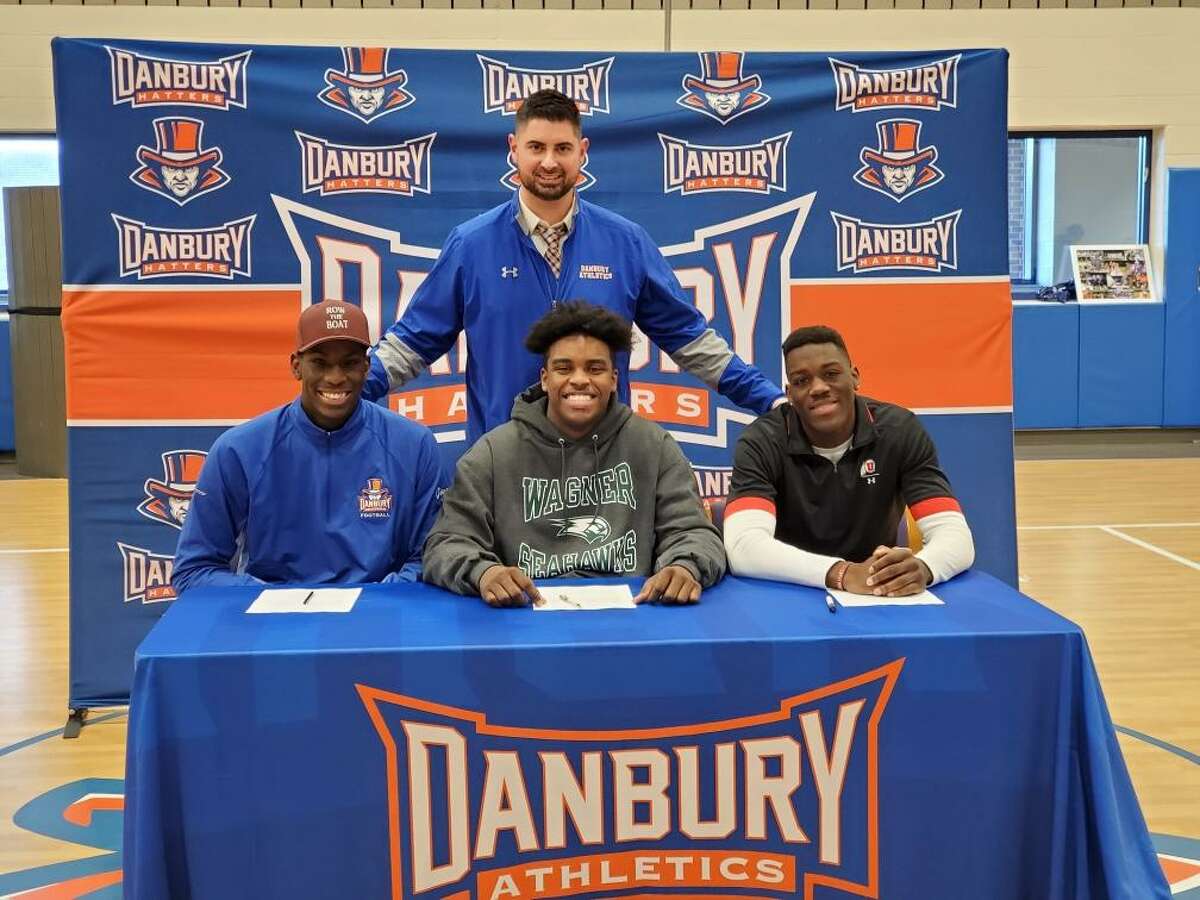 Jah Joyner (Minnesota), left, is joined by Kile Jackson (Wagner) and Pierre Moudourou (Utah), who all signed their letters of intent to play college football on Wednesday. Moudourou graduated from Danbury in 2016 and is heading to Utah from Monroe College in New York.