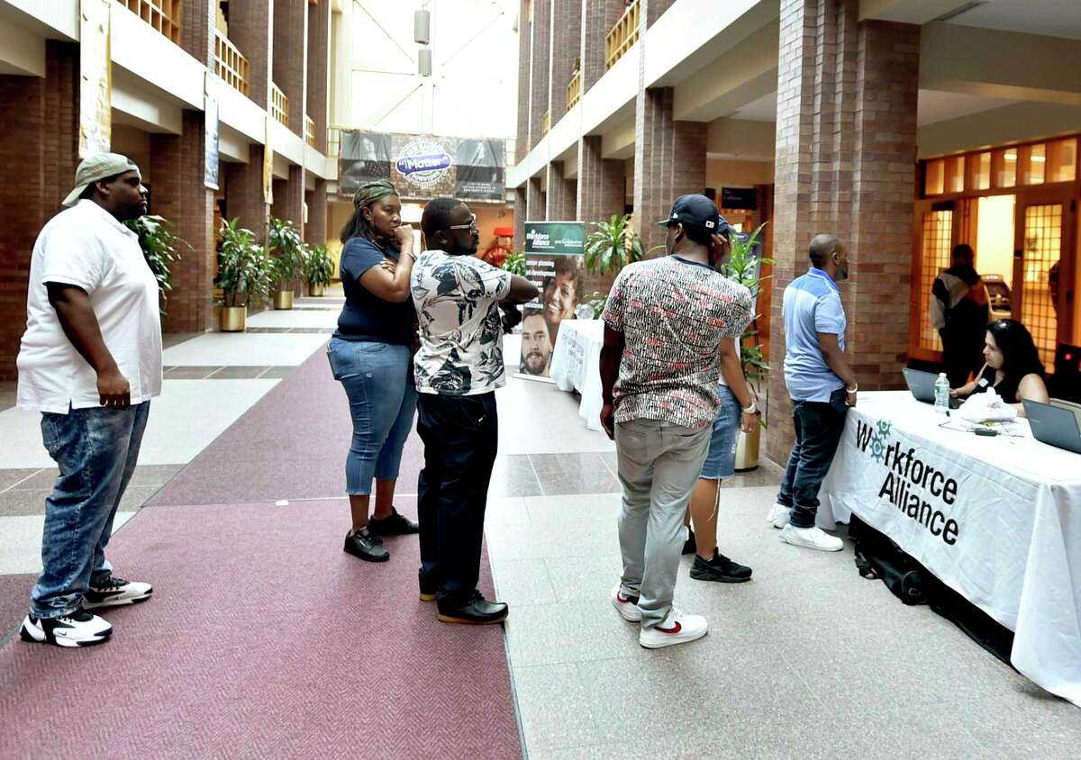 People line up to pre-register for interviews for approximately 1,800 Amazon North Haven warehouse facility job openings during a job fair in New Haven, Conn., on Aug. 30, 2019. Connecticut has gained 13,300 jobs in the past year, including 4,000 in February 2020.