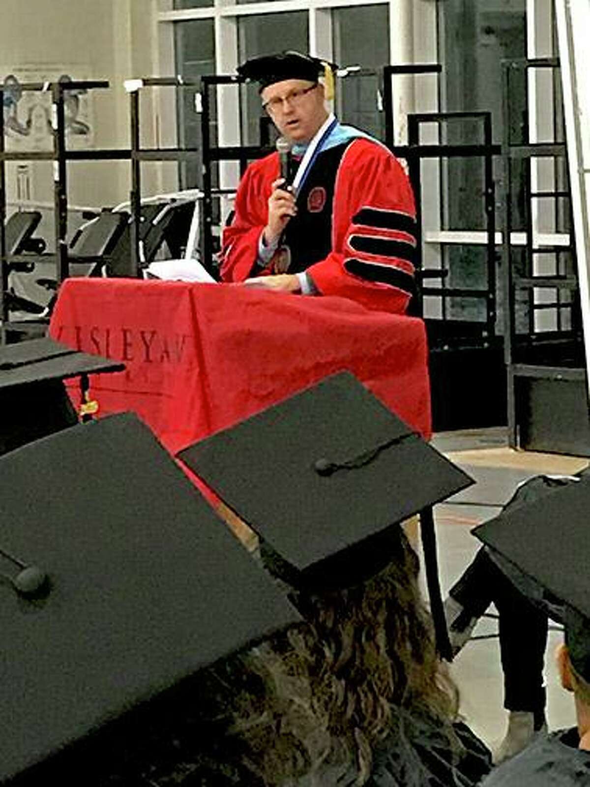 Dr. Steven Minkler, campus chief executive officer, Middlesex Community College, addresses graduates and attendees of the graduation ceremony at York Correctional Institution Tuesday.