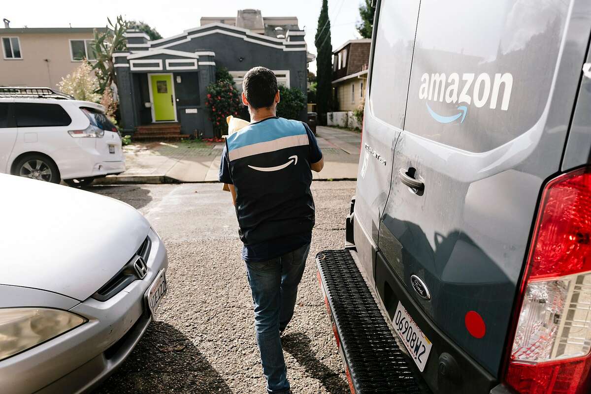An Amazon delivery driver prepares to drop off packages to residents in Oakland, California, Thursday, December 19th, 2019.