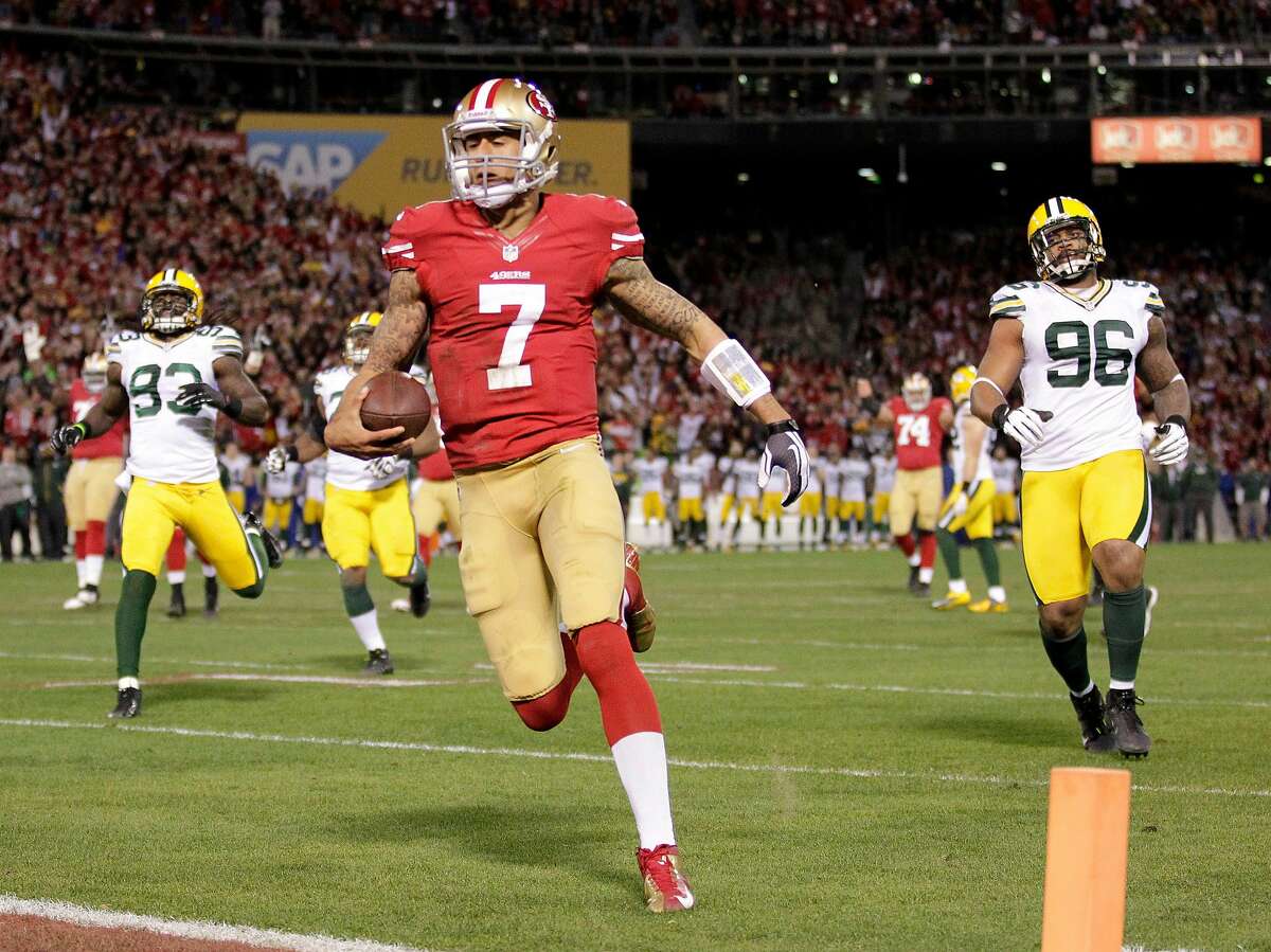 San Francisco 49ers quarterback Colin Kaepernick (7) runs for a 20-yard touchdown against the Green Bay Packers during the first quarter of an NFC divisional playoff NFL football game in San Francisco, Saturday, Jan. 12, 2013. (AP Photo/Tony Avelar)
