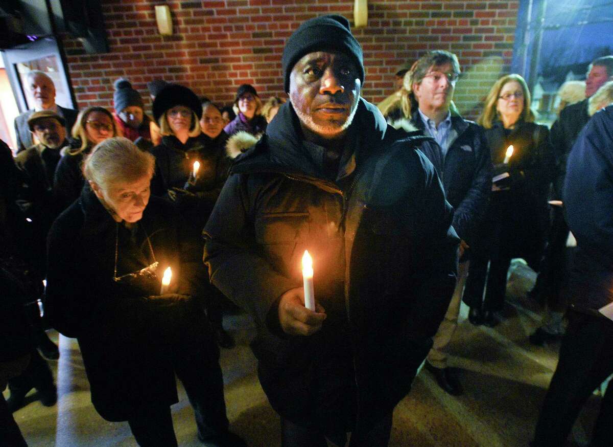 Leroy Masheck of Stamford stands with others as they hold a candle light vigil during a Homeless Persons' Memorial Service at the Bethel AME Church in Stamford, Conn. on Dec. 19, 2019. Masheck, who was formerly homeless joined with several local clergy, community agencies, city and state leaders, and Stamford residents in Darkness to Light, as they remember those forgotten and those working to end homelessness on National Homeless Persons' Memorial Day.