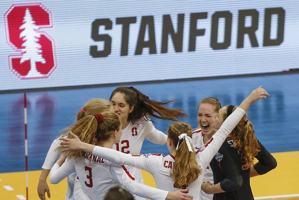 Stanford's Audriana Fitzmorris (12) and Holly Campbell (3) celebrate with teammates after Stanford defeated Minnesota in the semifinals of the NCAA Division I women's volleyball championships Thursday, Dec. 19, 2019, in Pittsburgh. Stanford will face Wisconsin in the championship match Saturday. (AP Photo/Keith Srakocic)
