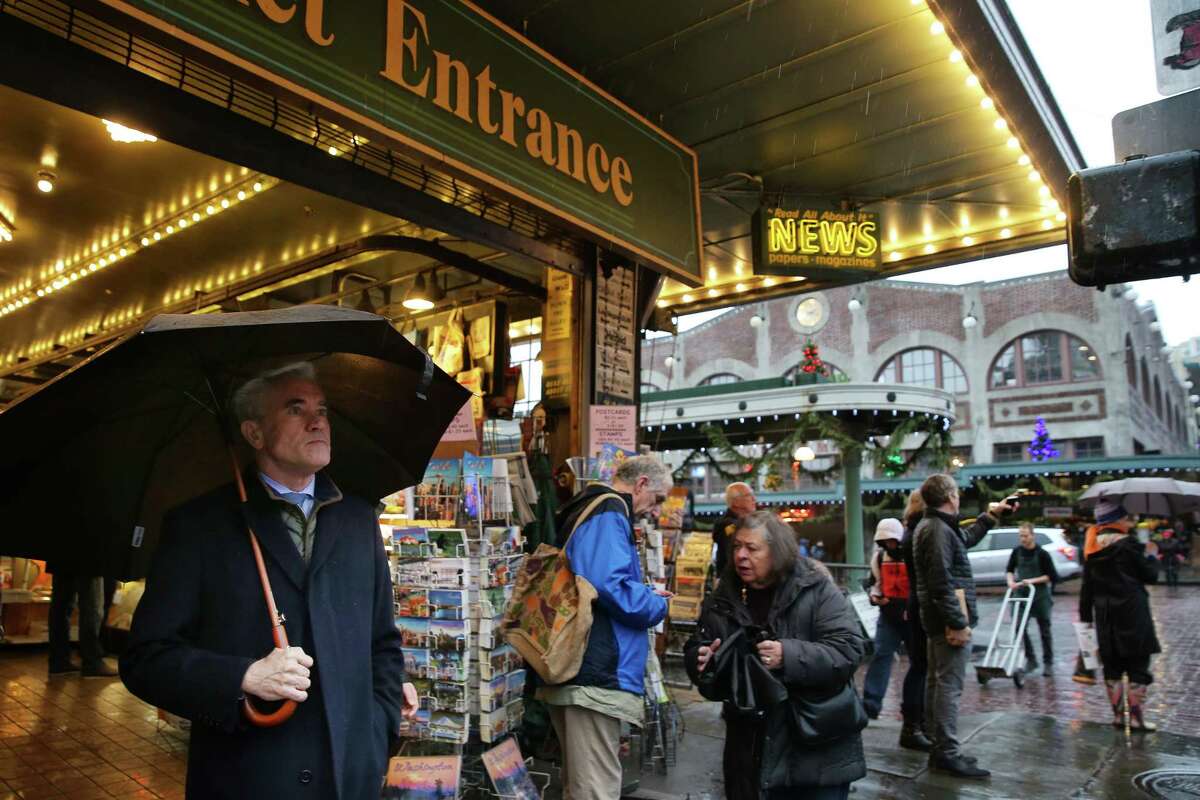 Pedestrians pass by Pike Place landmark First and Pike News, which will close down on Dec. 31 after 40 years of newpaper and magazine sales. Owner Lee Lauckhart says that business has dwindled more and more in recent years.