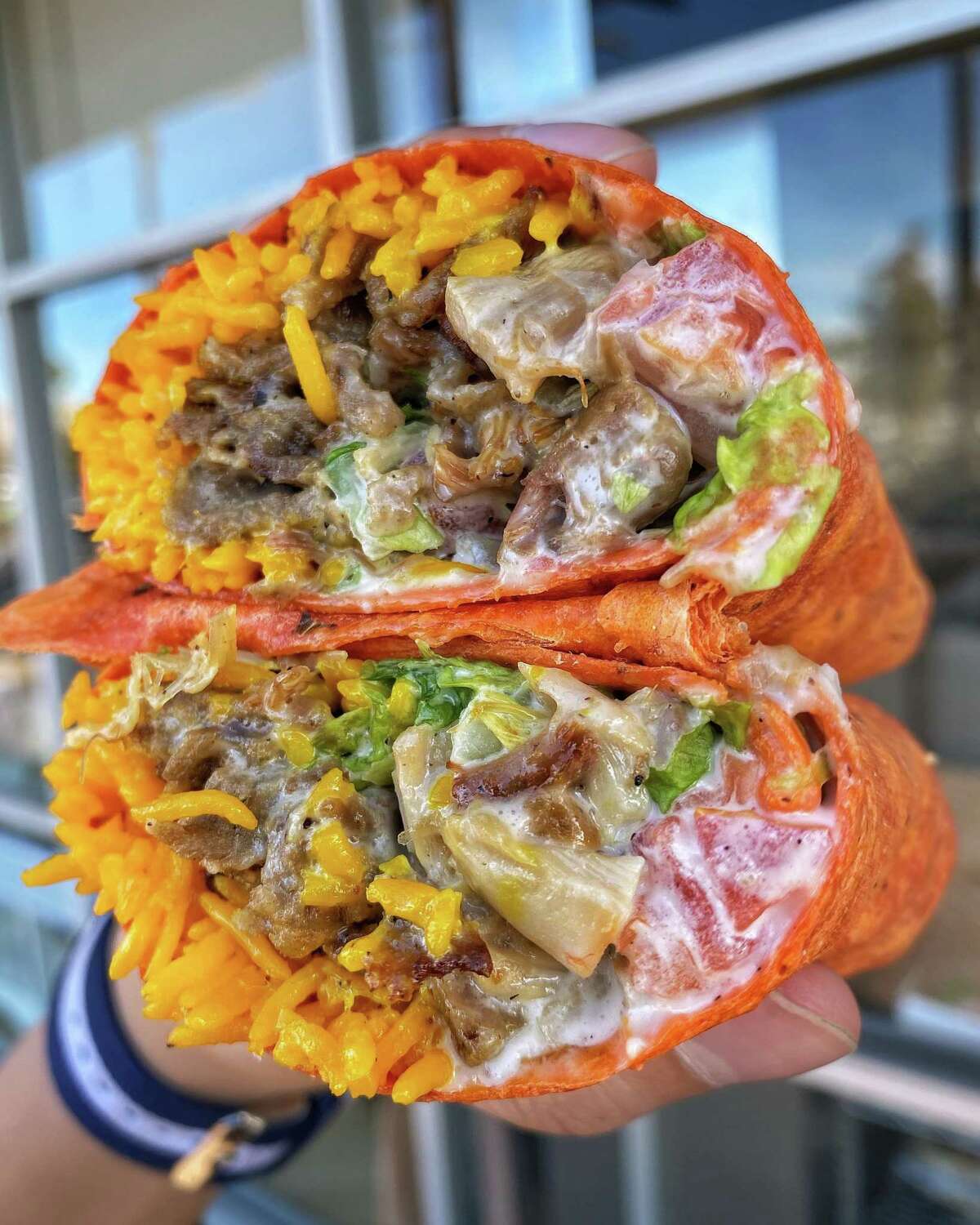 The Halal Guys is offering a new burrito stuffed with a variety of fillings, a cheese white sauce and built with a sundried tomato tortilla.
