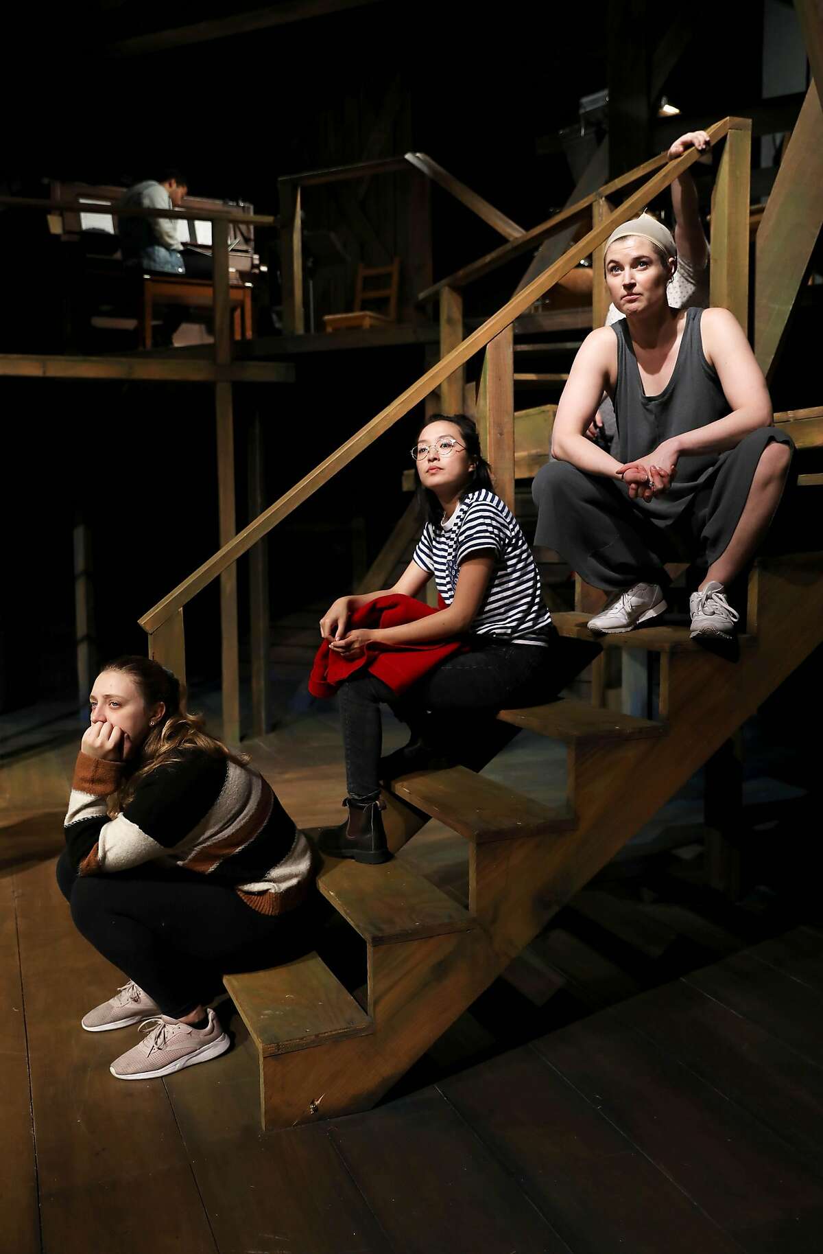 Vinegar Tom cast members Lyndsee Bell, left, Sharon Shao, and Amanda Farbstein listen to instructions during rehearsal at Shotgun Players in Berkeley, Calif., on Wednesday, December 11, 2019. The theater company reclassified actors, stage managers, set building, lighting team as employees a few year ago after a state audit, and is raising money for a fund to cover the extra expenses of doing so.
