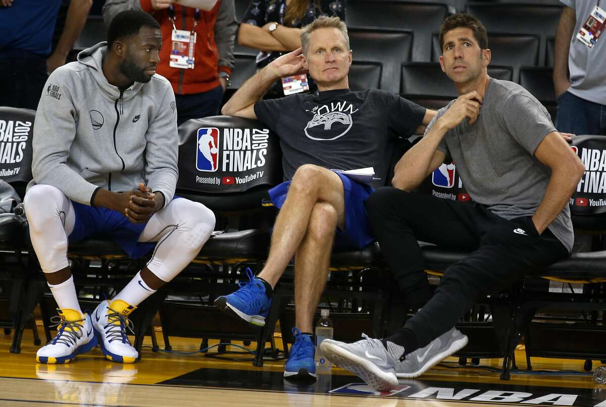 Draymond Green sits on the bench with head coach Steve Kerr and general manager Bob Myers during a Golden State Warriors practice at Oracle Arena in Oakland, Calif. on Wednesday, June 12, 2019 before Thursday's Game 6 of the NBA Finals against the Toronto Raptors.