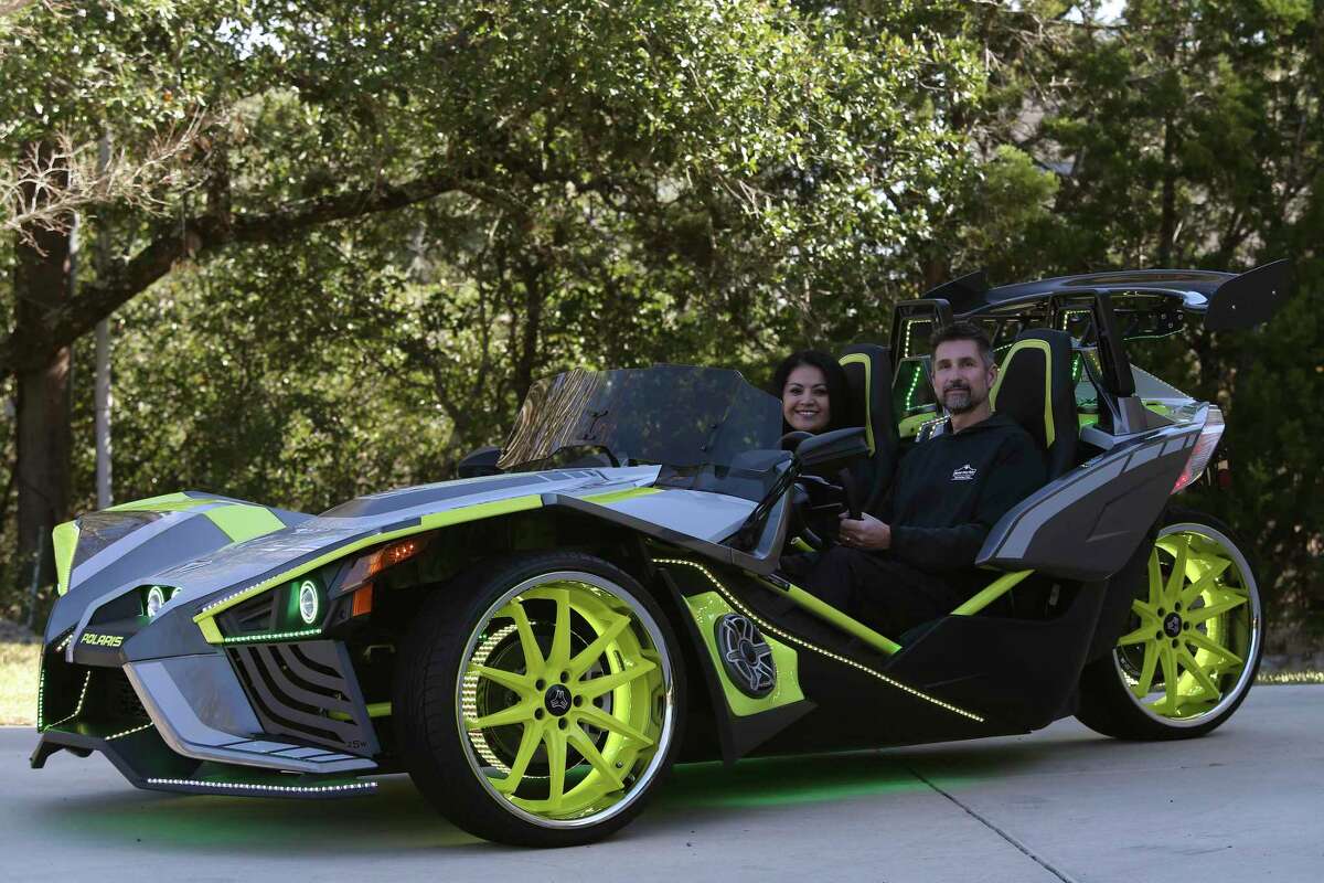 Arnold Rabel, 46, and his wife, Alisha, 45, show off their Polaris Slingshot, a three-wheel motorcycle. The Slingshot is available in several models priced between $20,000 and $30,000.