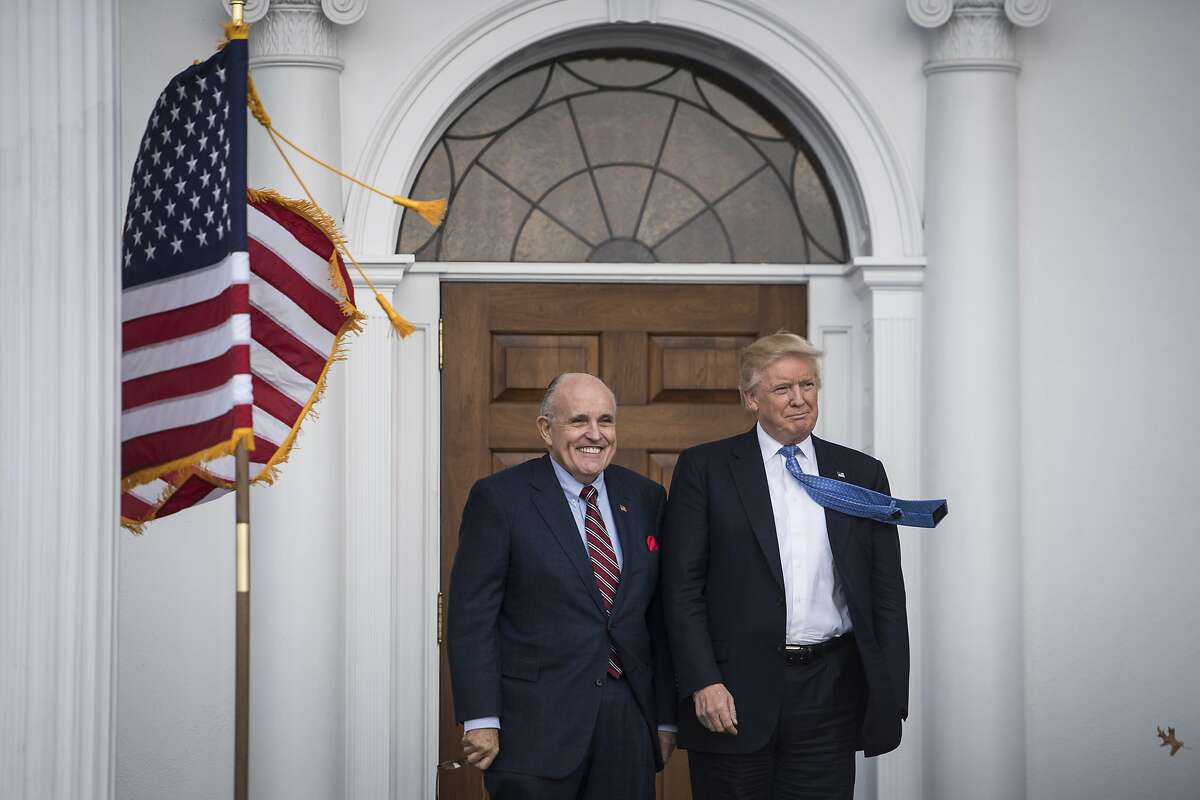 BEDMINSTER TOWNSHIP, NJ - NOVEMBER 20: President-elect Donald Trump greets Rudy Giuliani at the clubhouse at Trump National Golf Club Bedminster in Bedminster Township, N.J. on Sunday, Nov. 20, 2016. (Photo by Jabin Botsford/The Washington Post via Getty Images)