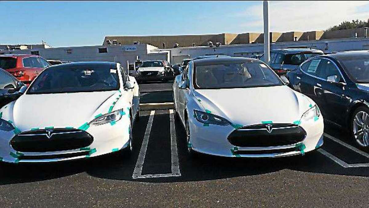 New Tesla electric cars parked at the company's Milford Service center on the Boston Post Road, in November 2015, waiting to be outfitted and then delivered to buyers.
