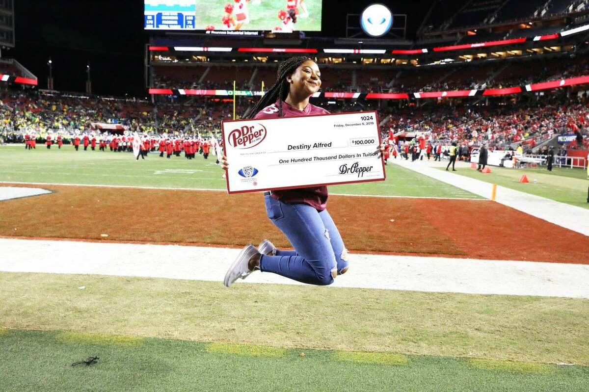 Destiny Alfred of Spring jumps for joy after winning $100,000 through the Dr Pepper Tuition Giveaway. The competition occurred at the PAC 12 Conference Championship game Dec. 6, 2019.