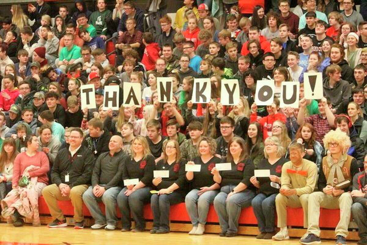 Students and staff surprised Scharlow by holding up cards that spelled out, "thank you." (Herald Review photo/Catherine Sweeney)
