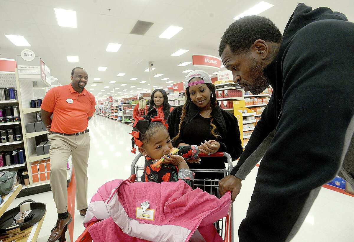 Stephen Jackson talks with DerrVonne LeBlanc as she and her mother Javonne Johnson arrive to join in the Christmas with a Champion event at Target Saturday. The Port Arthur native and former NBA champion donated gift cards to 100 families to purchase gifts for the holidays. Photo taken Saturday, December 8, 2018 Kim Brent/The Enterprise