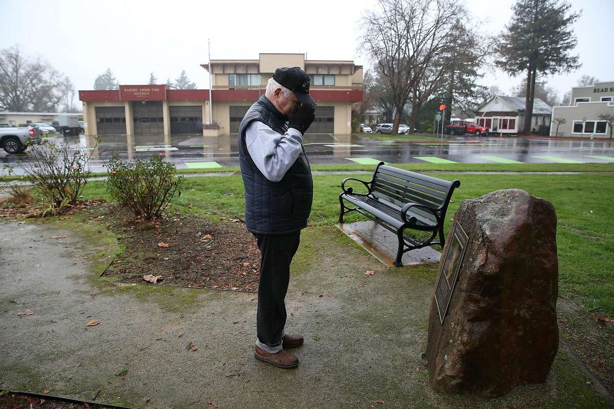 Bruce Voorhees salutes a memorial to his friend Robert Coleman-Senghor, while visiting a memorial to Coleman-Senghor at La Plaza Park on Wednesday, December 18, 2019 in Cotati, Calif. Voorhees and Coleman-Senghor both served in the Marines among other connections.