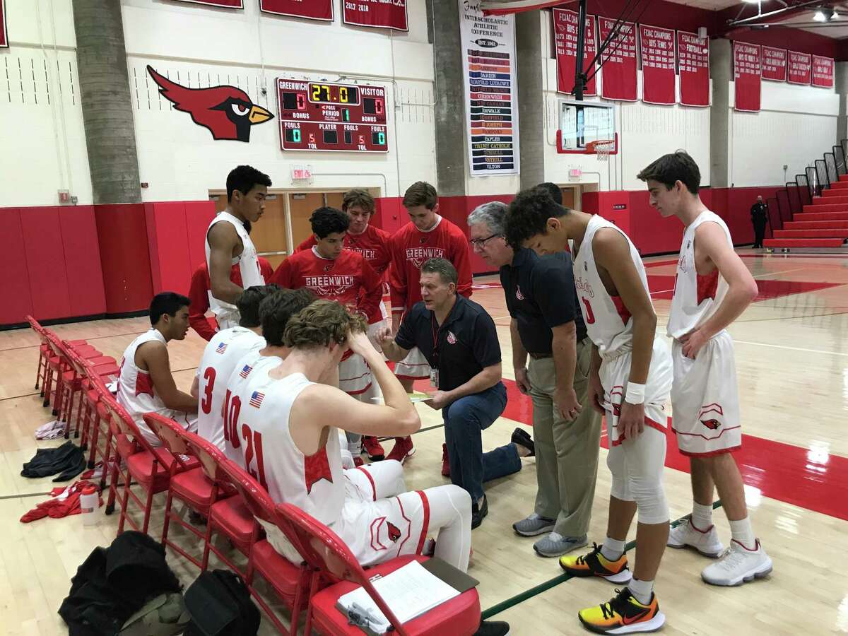 The Greenwich boys basketball team gathers prior to its home game against Hamden on Saturday, December 21, 2019.