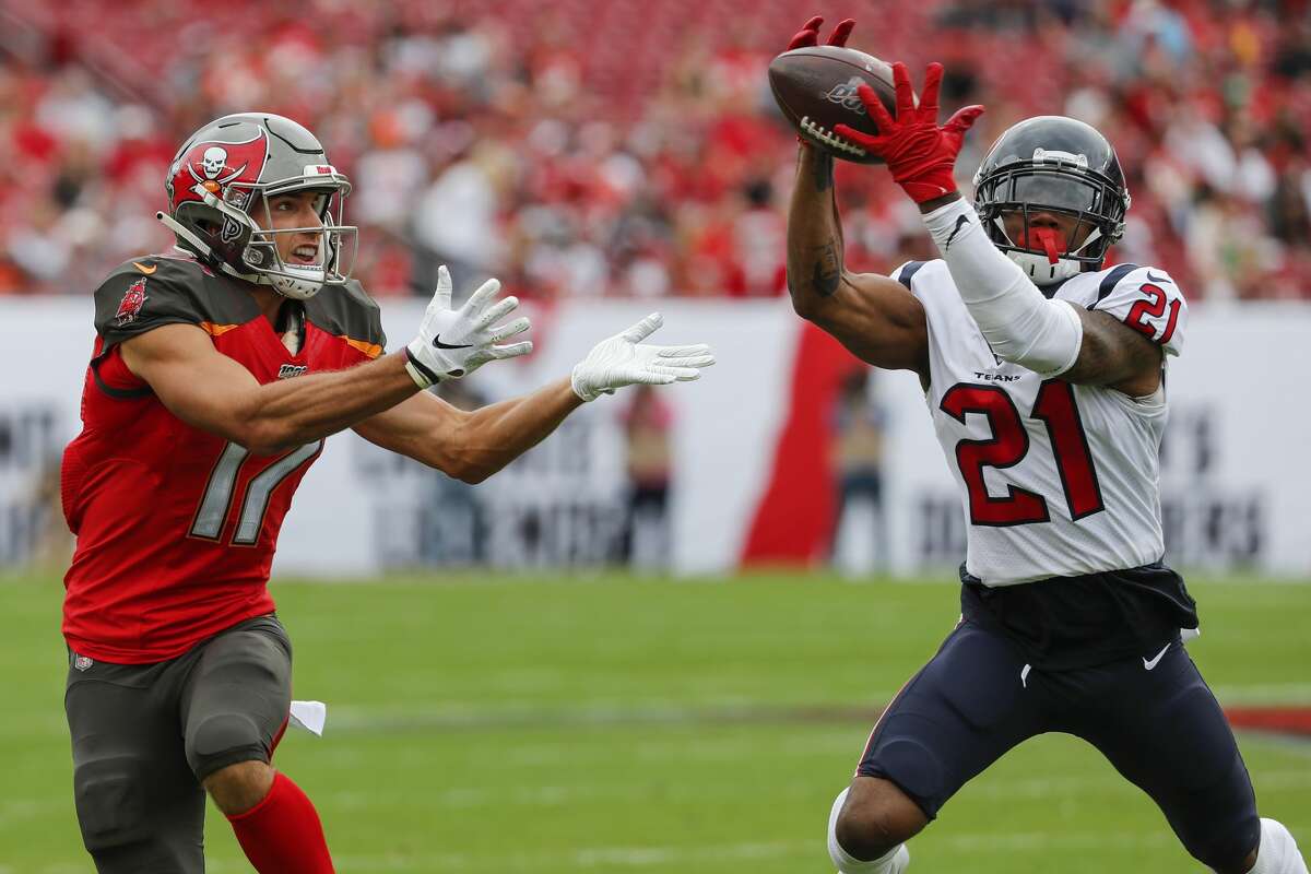 Houston Texans cornerback Bradley Roby (21) leaps in front of Tampa Bay Buccaneers wide receiver Justin Watson (17) for an interception that he returned for a touchdown during the first quarter of an NFL football game at Raymond James Stadium on Saturday, Dec. 21, 2019, in Tampa.