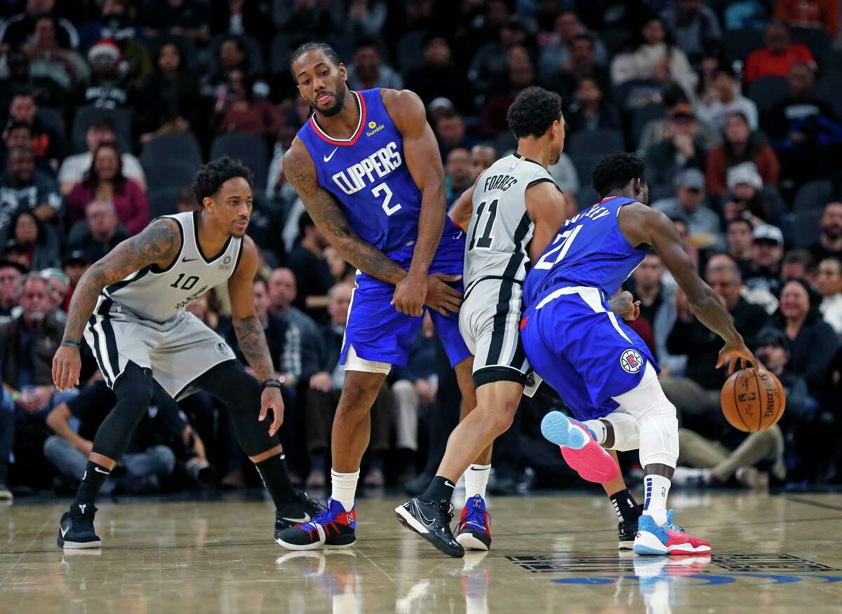 Kawhi Leonard #2 #2 of the Los Angeles Clippers tries to set a screen on Bryn Forbes #11 of the San Antonio Spurs in first half action on Saturday, December 21, 2019