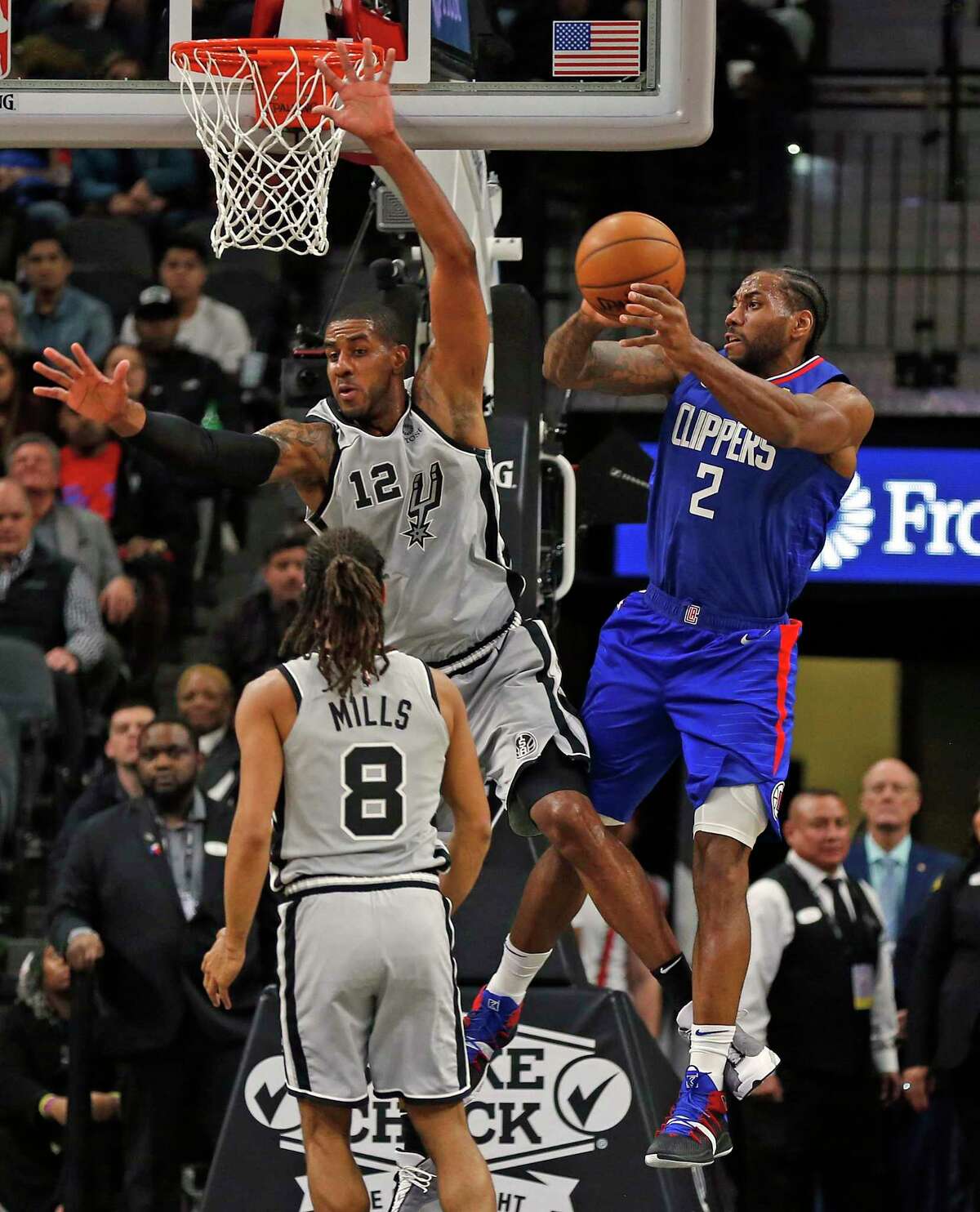 Kawhi Leonard #2 of the Los Angeles Clippers grabs a rebound next to LaMarcus Aldridge #12 of the San Antonio Spurs in first half action on Saturday, December 21, 2019