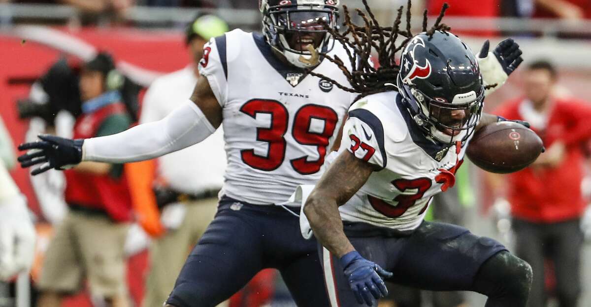 Houston Texans strong safety Jahleel Addae (37) and free safety Tashaun Gipson (39) celebrate Addae's interception of a pass by Tampa Bay Buccaneers quarterback Jameis Winston during the fourth quarter of an NFL football game at Raymond James Stadium on Saturday, Dec. 21, 2019, in Tampa.