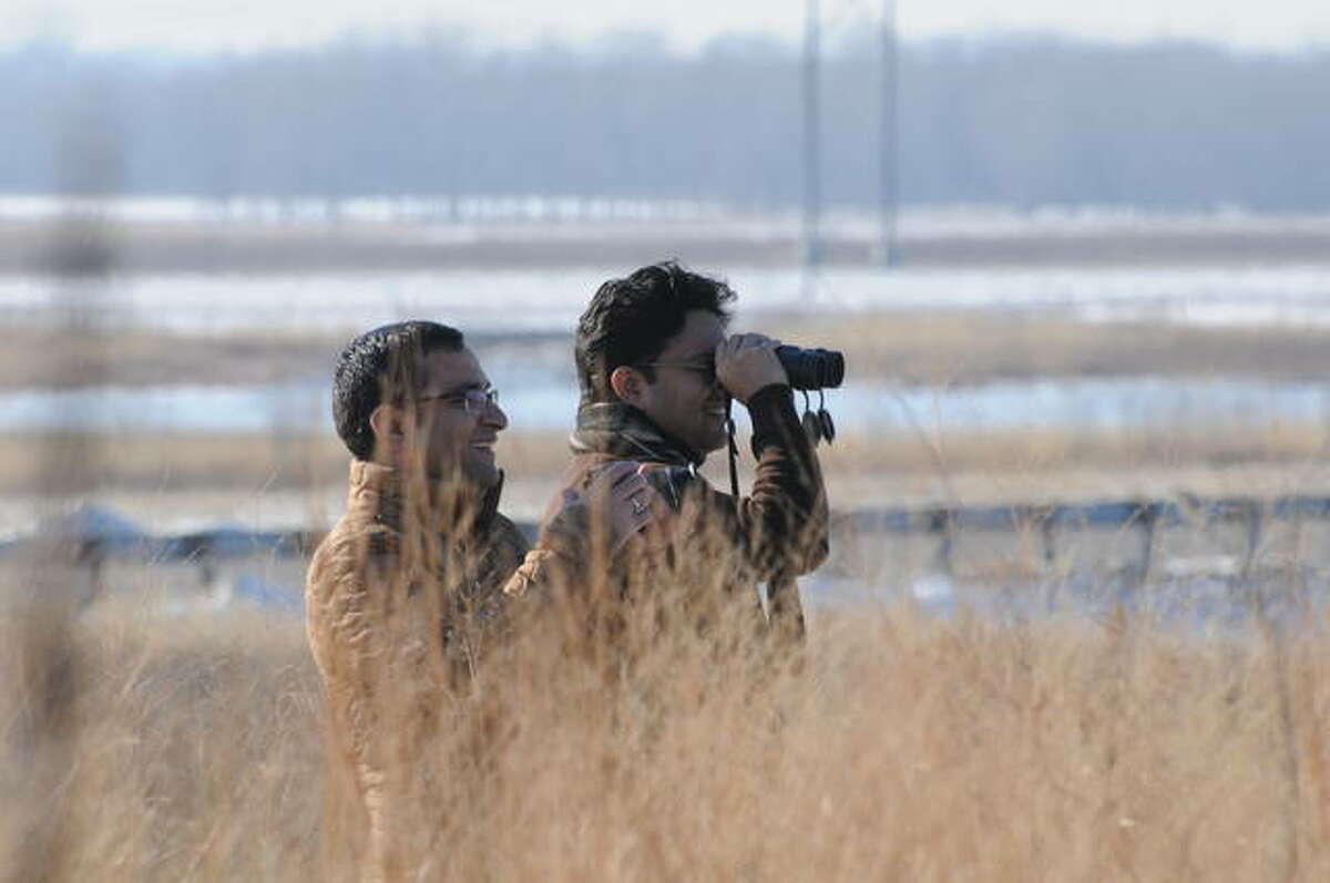 Sumit Joshi and Sidhartha Mahali of St. Louis observe winter birds on Saturday at the Audubon Center at the Riverlands.