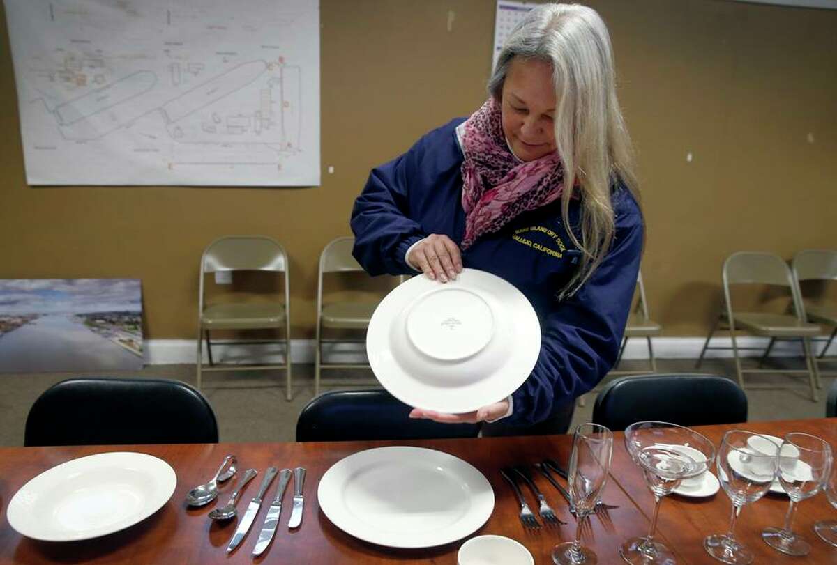 Christina Snyder, executive vice president of Mare Island Dry Dock, holds dishware that was salvaged from the Sherman.