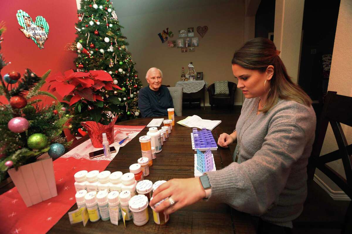 Anna Moreno sorts medication for her father, Mark Blair, a liver transplant recipient, in Seguin on Wednesday, Dec. 18, 2019. Moreno wanted to donate part of her liver to her father but wasn’t a match, so she participated in a paired exchange, where she donated to a stranger, in exchange for a donation from someone close to that person.