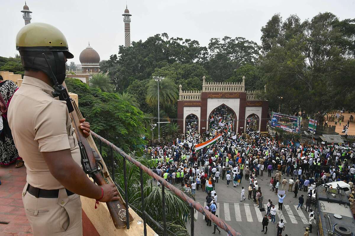 A security personnel stands guard as demonstrators arrive to take part in a rally against India's new citizenship law in Bangalore on December 23, 2019. (Photo by Manjunath Kiran / AFP) (Photo by MANJUNATH KIRAN/AFP via Getty Images)