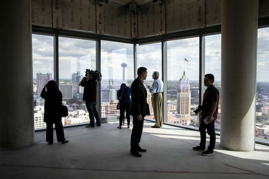 Members of the media look out of the windows on the 24th floor penthouse of the new Frost Tower Building in downtown San Antonio on Sept. 17, 2019. Photo: JOSIE NORRIS/The San Antonio Express-News
