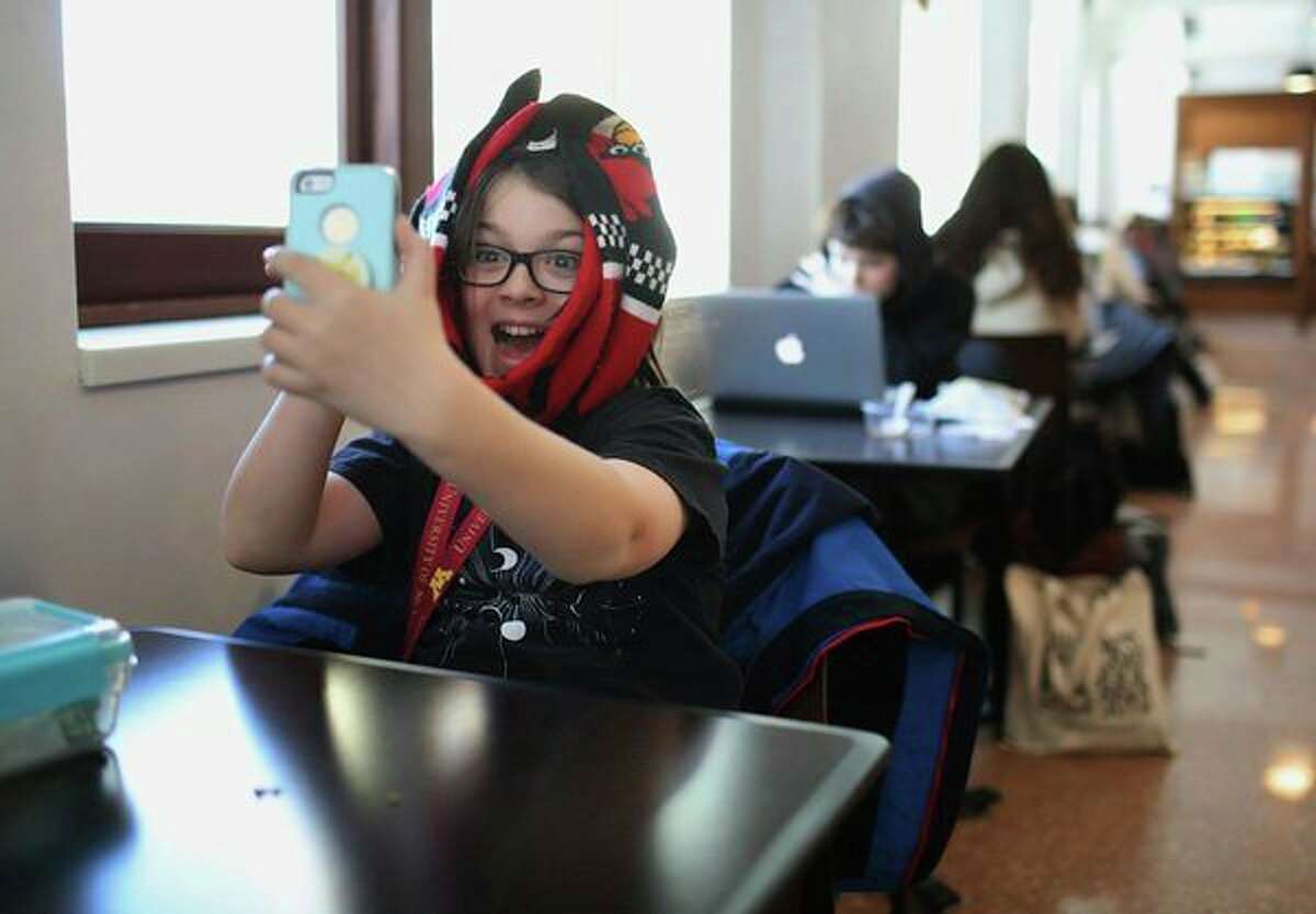 Elliott Tanner, 11, a junior at the University of Minnesota, from St. Louis Park, takes a selfie in the Surdyk's Cafe in Northrup Auditorium, where he was having lunch with his mom Michelle, on Wednesday, Dec. 11, 2019, at the University of Minnesota in Minneapolis, Minn. (David Joles/Minneapolis Star Tribune/TNS)