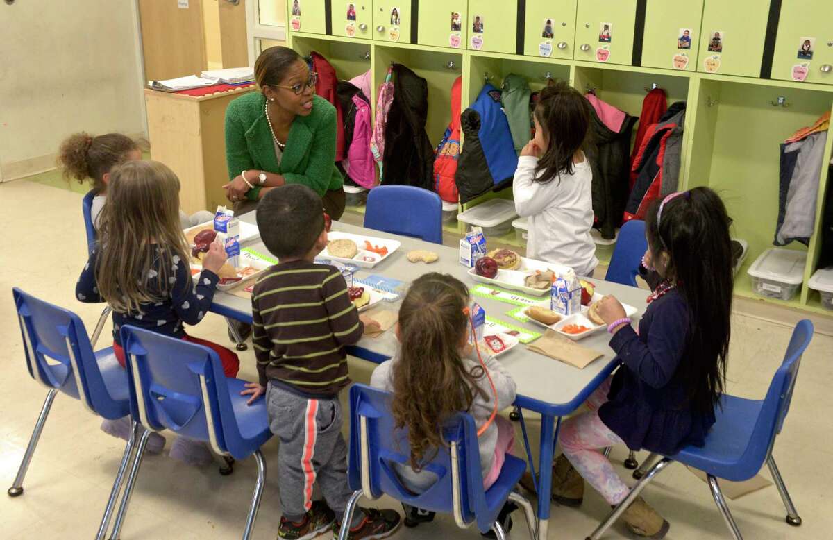 Nichole Taxiltsridis, the new director of early learning programs at the Connecticut Institute For Communities, talks with students enjoying lunch at Head Start in Danbury, Conn. Thursday, December 19, 2019.