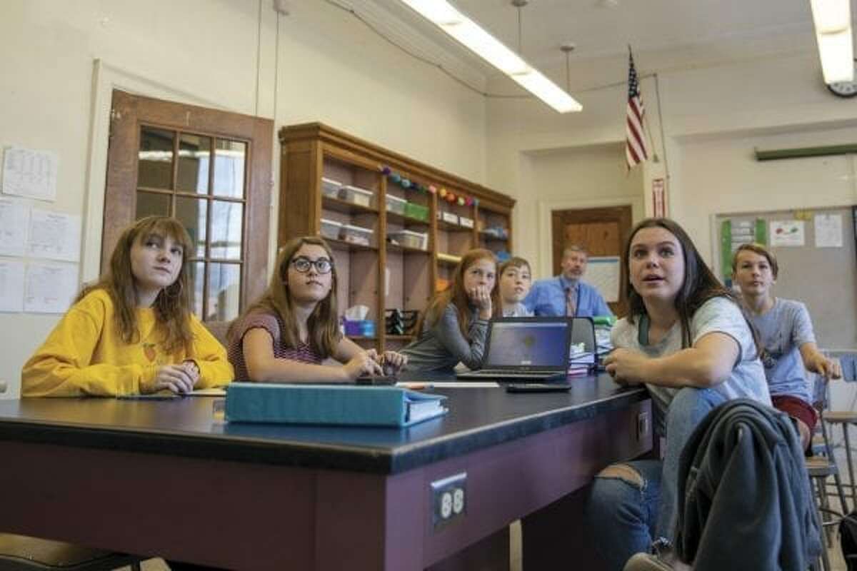Allison Benway (front left) and Emma Olcott (right) participate in the seventh-grade math class at Boquet Valley’s Lake View Campus in Westport. (Photo by Mike Lynch/Adirondack Explorer)
