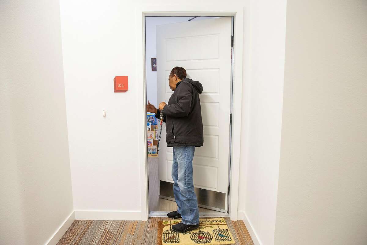Leola Brown, 69, closes her apartment door at BRIDGE Housing on Thursday, Dec. 19, 2019, in San Francisco, Calif. Brown lived across the street at 26th and Wisconsin streets for more than four decades before moving into BRIDGE Housing. The block of her former home is being demolished and developed with hundreds of apartments, as part of the Potrero HOPE SF project.