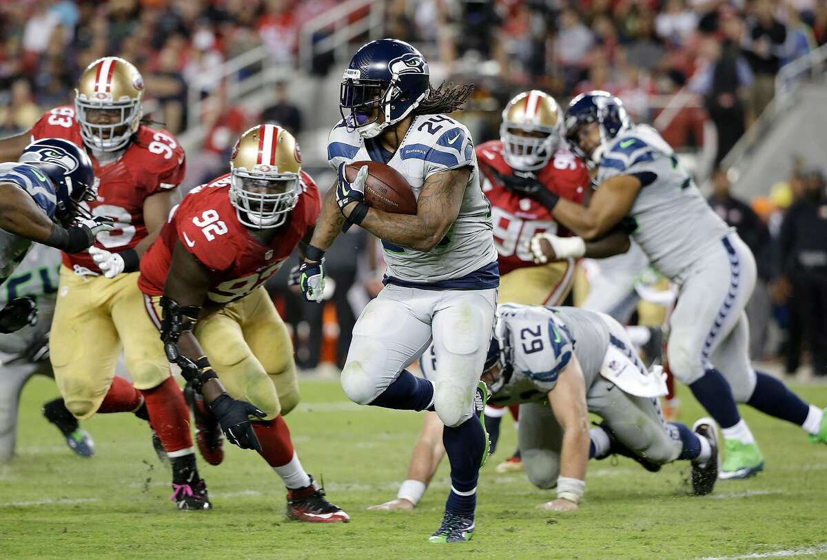 FILE - In this Oct. 22, 2015, file photo, Seattle Seahawks running back Marshawn Lynch (24) runs against San Francisco 49ers defensive end Quinton Dial (92) during the second half of an NFL football game in Santa Clara, Calif. Marshawn Lynch has rejoined the Seattle Seahawks just in time for the playoffs. Coach Pete Carroll said on his radio show Monday morning, Jan. 4, 2016, that Lynch was back at the team's facility after missing the final seven games of the regular season and undergoing abdominal surgery. (AP Photo/Marcio Jose Sanchez, File)