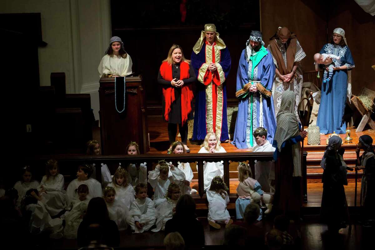 Pastor Emily Chapman, center in the red scarf, speaks to the audience during the Christmas pageant at St. Mark's United Methodist Church on Saturday, Dec. 21, 2019.